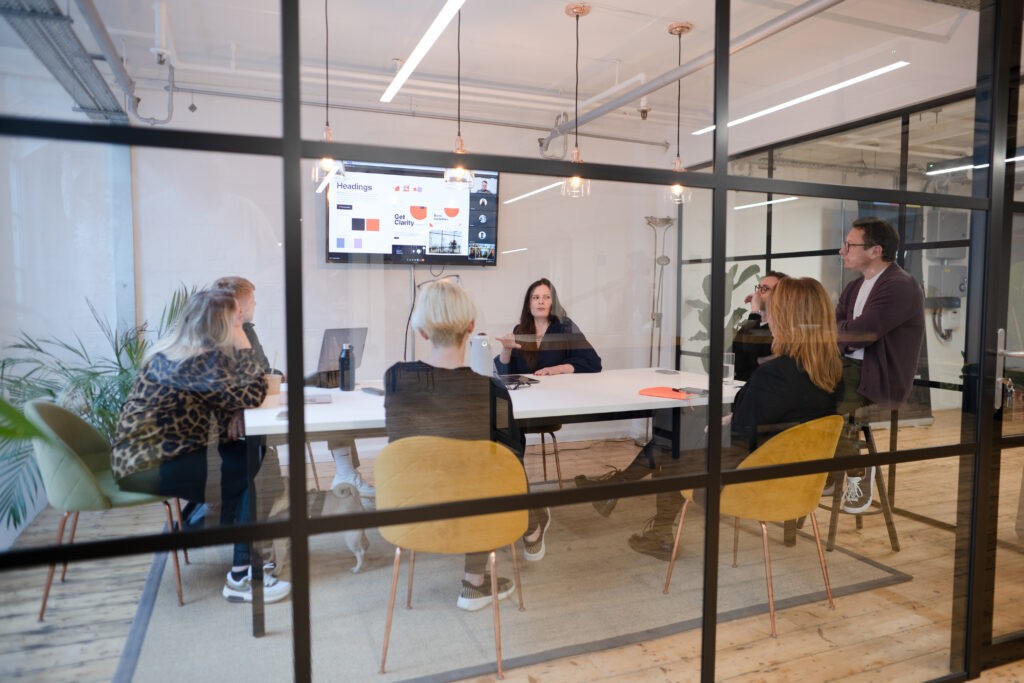 A design briefing in a glass panelled meeting room